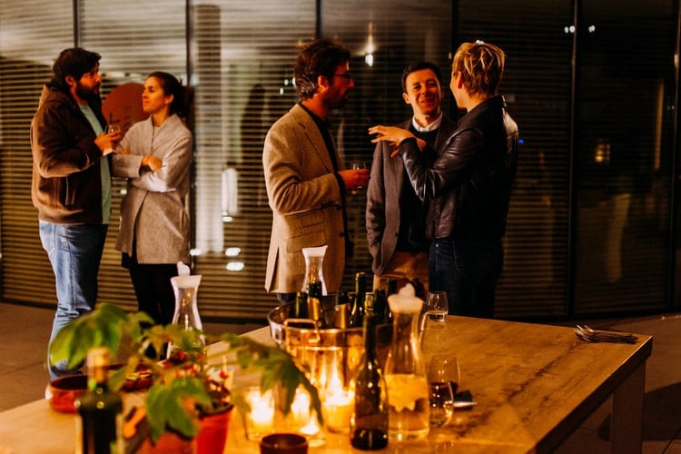 People talking at a dinner party.