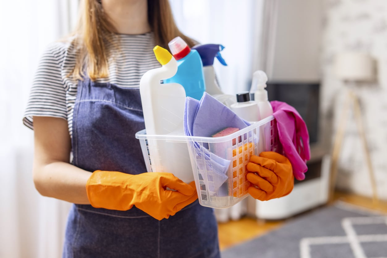 Woman holding cleaning supplies for spring clean. 