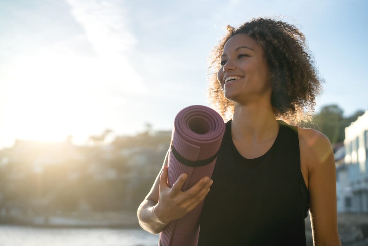 Happy woman with a yoga map.