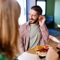 Man with hearing aids has dinner