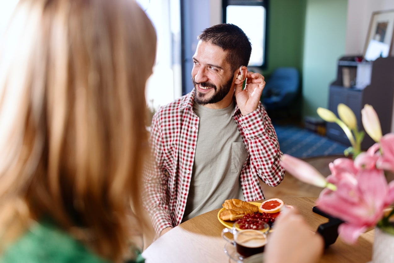 Man with hearing aids has dinner