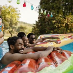 Group of friends sitting on a pool floaty