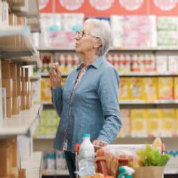 Senior woman doing grocery shopping at the supermarket